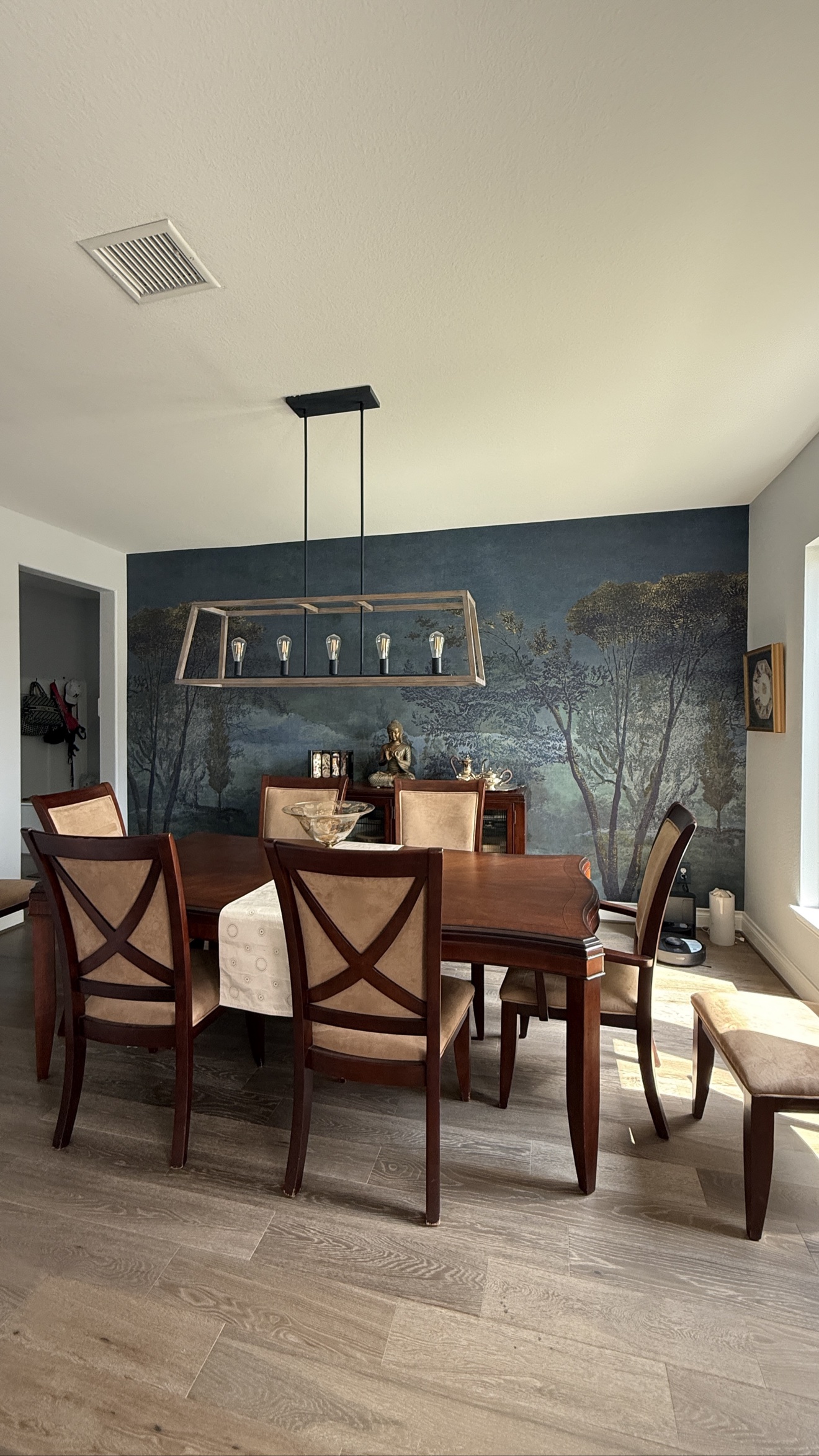 Moody landscape mural installed in a furnished dining room