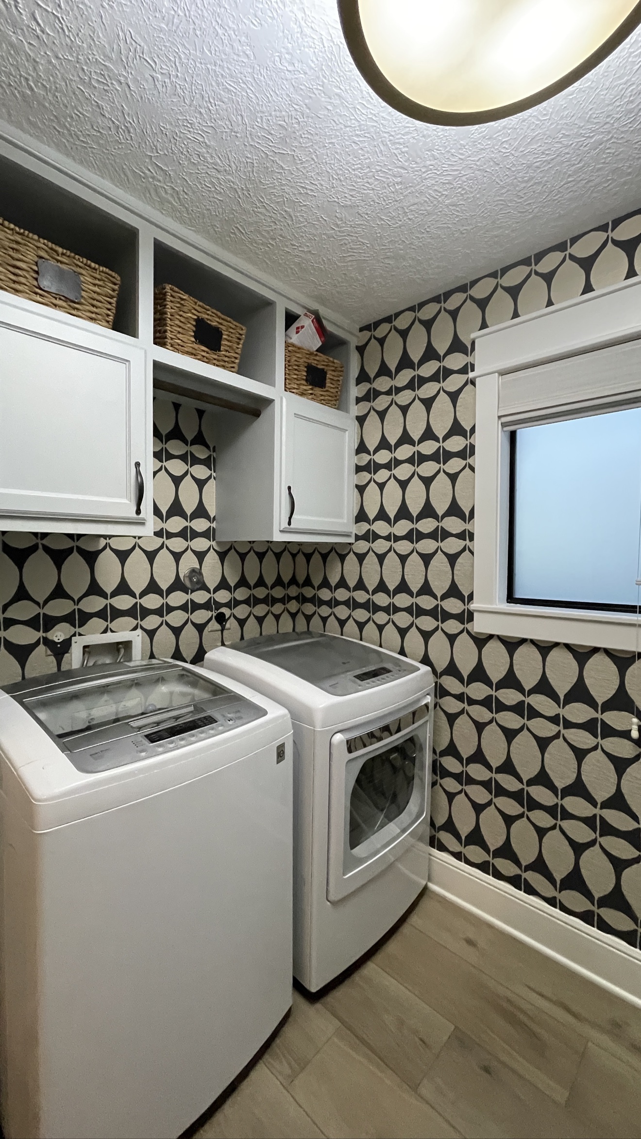 Geometric wallpaper installed in a laundry room