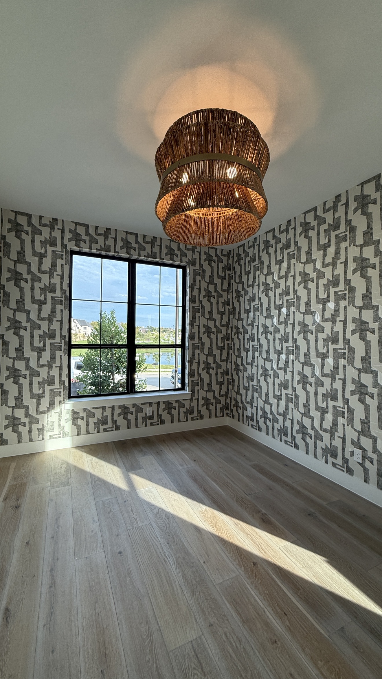 Black and gray geometric wallpaper installed in a bright room