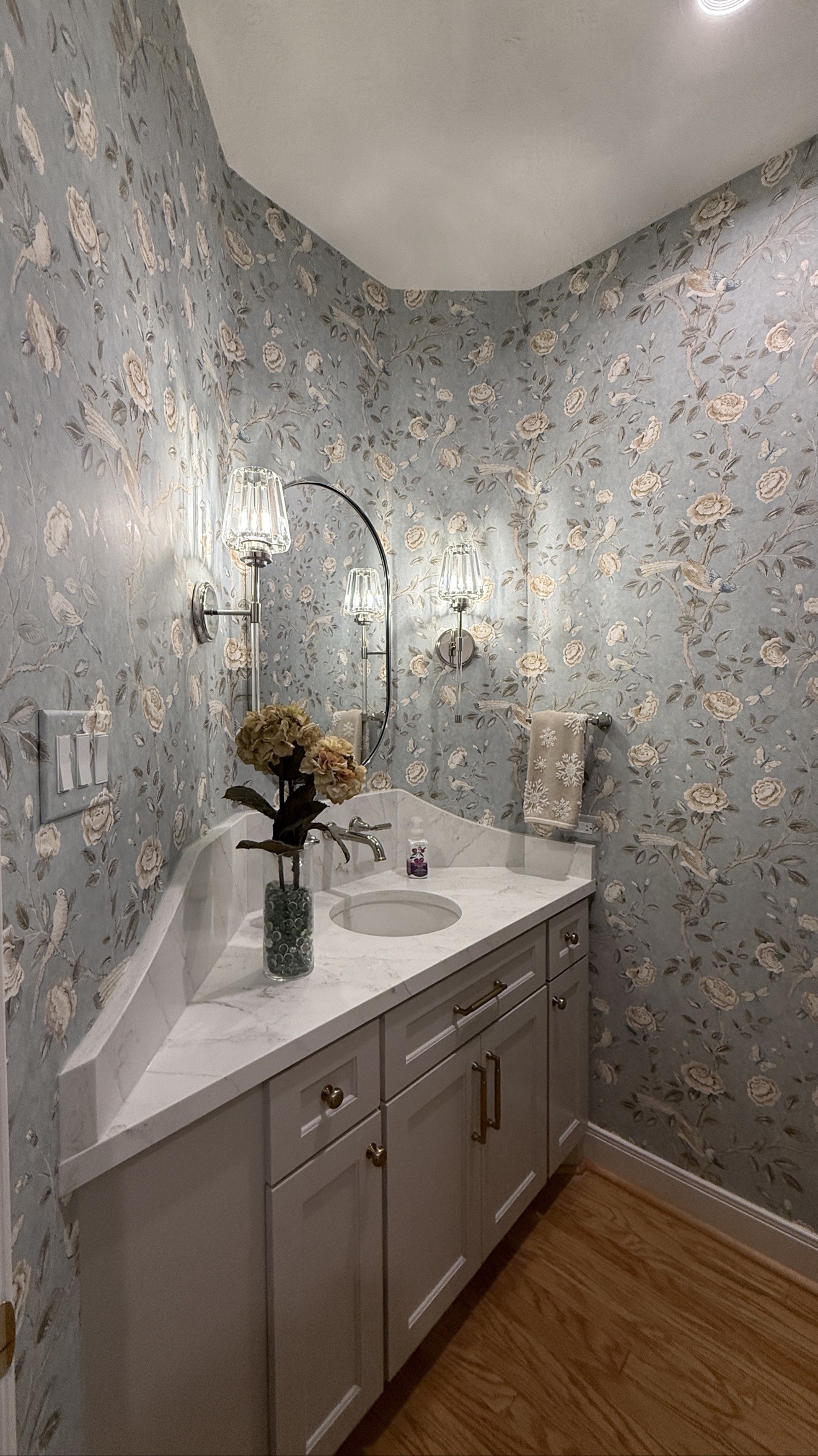 Soft blue floral wallpaper installed in a bathroom