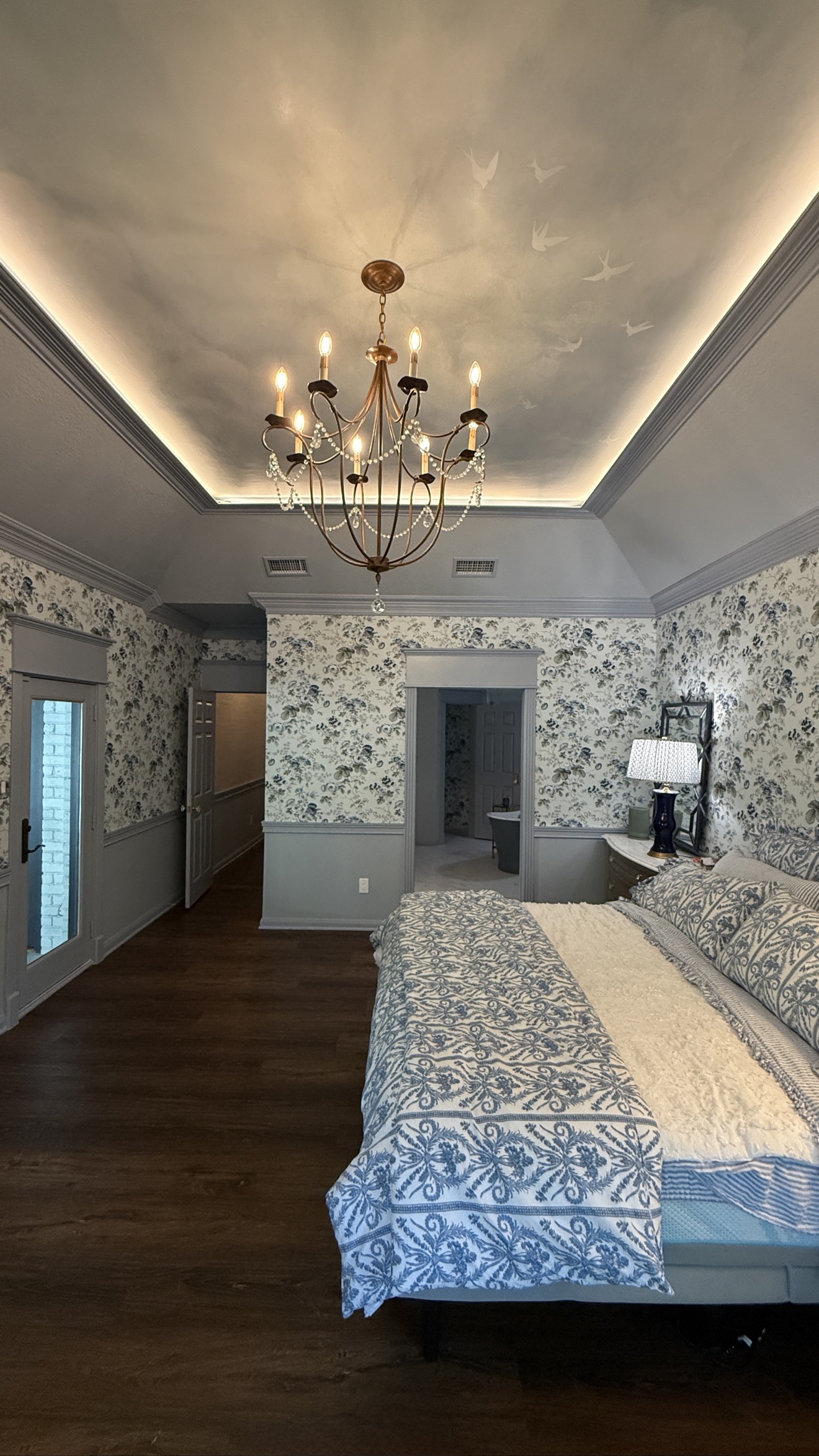Bird mural wallpaper installed across a bedroom ceiling