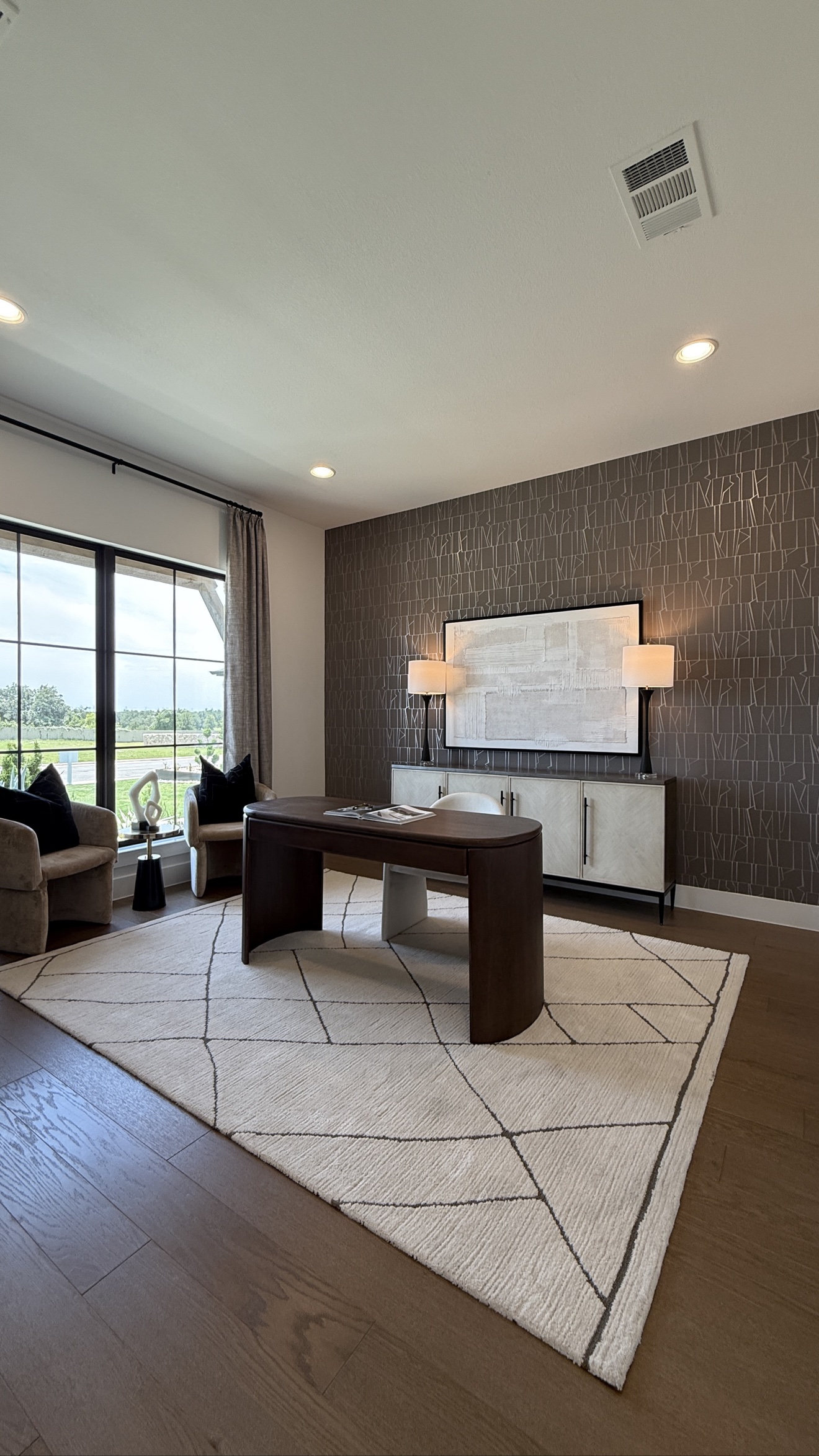 Dark geometric wallpaper installed as an office feature wall