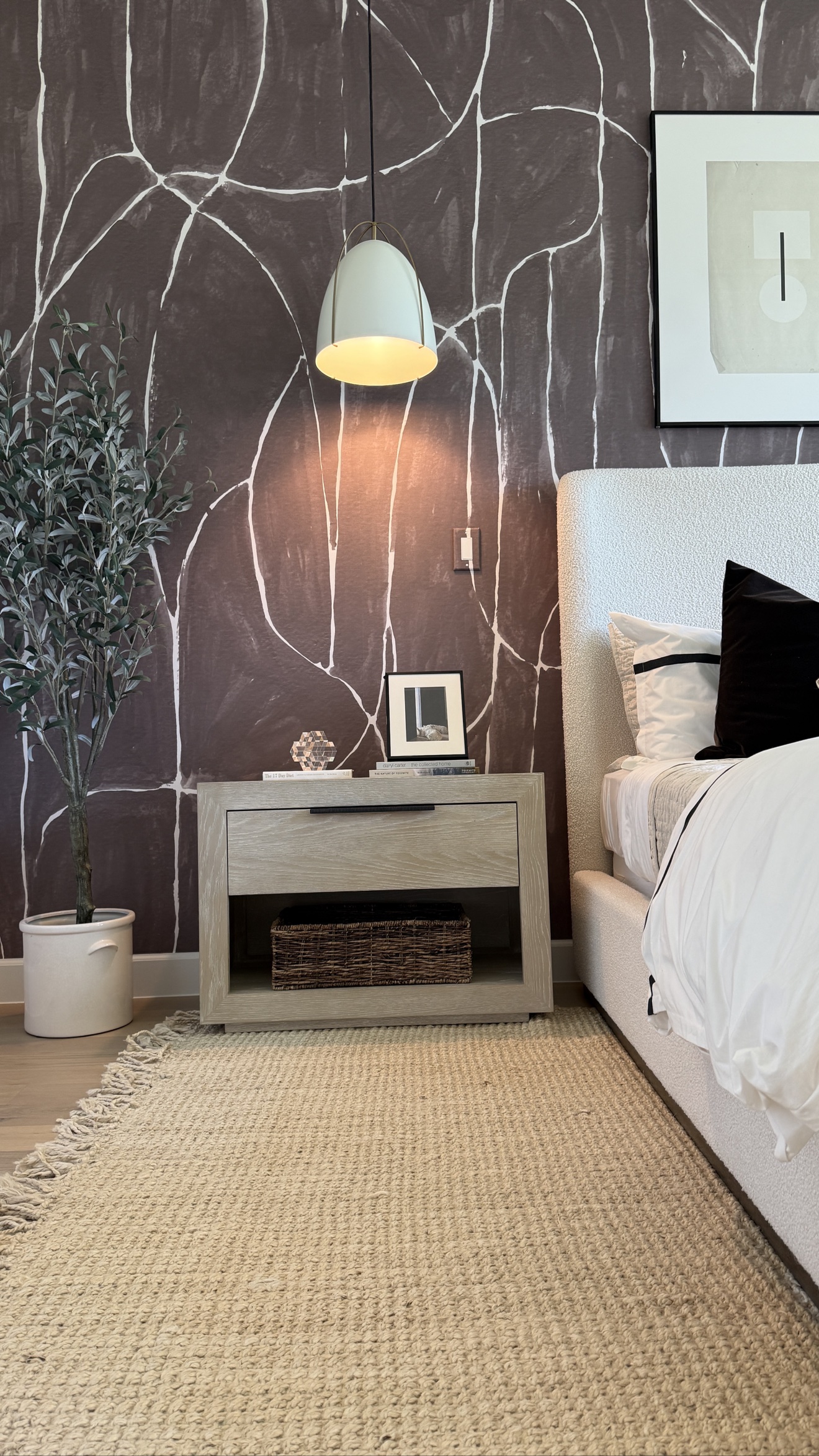 Dark abstract mural wallcovering installed behind a bedroom