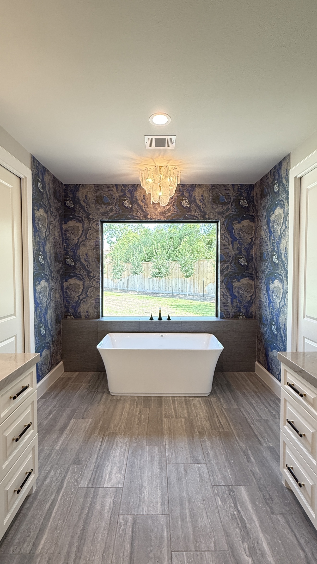 Blue marbled wallpaper installed in a bathroom
