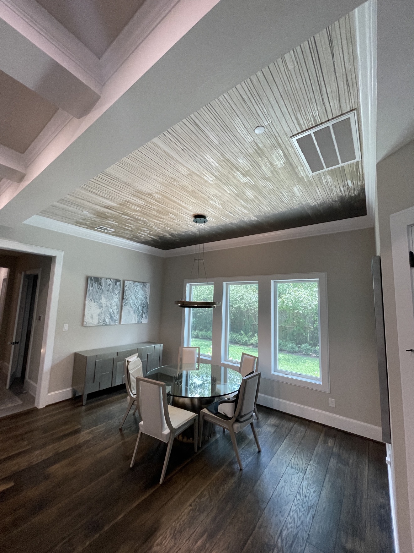Metallic textured wallcovering installed across a recessed dining room ceiling