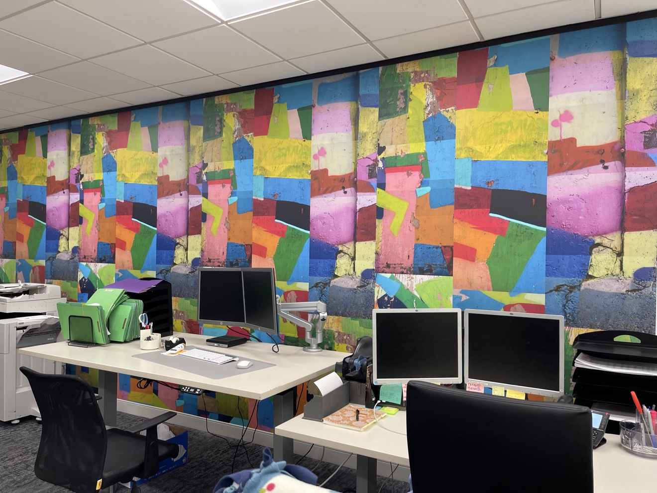 Colorful abstract mural wallcovering installed across a finished office wall