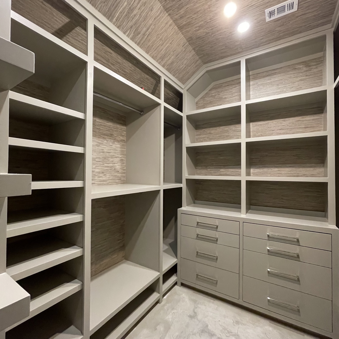 Neutral grasscloth installed inside a custom walk-in closet and across its ceiling